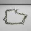 Silver chain bracelet on a light gray background