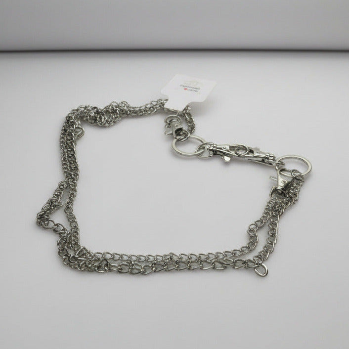Silver chain bracelet on a light gray background